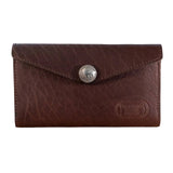 Brown leather wallet with a button on a light wooden surface